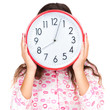 Child in pajamas wearing a clock in place of her face