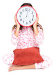 Photo: Child in pajamas wearing a clock in place of her face Child in pajamas wearing a clock in place of her face
