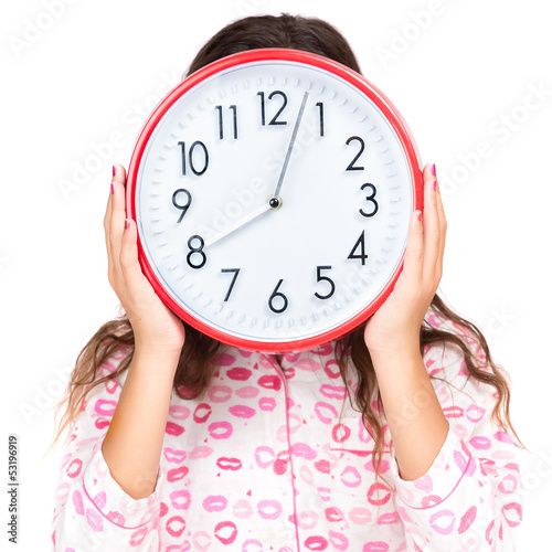 Photo: Child in pajamas wearing a clock in place of her face Child in pajamas wearing a clock in place of her face