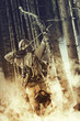 A male bow hunter wearing gas mask