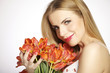 Foto: Beautiful blonde girl with the bouquet of tulips isolated on a w Beautiful blonde girl with the bouquet of tulips isolated on a w