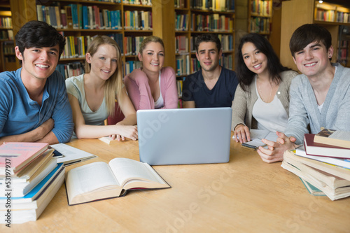 Photo: Six students learning in a library with a laptop Six students learning in a library with a laptop