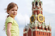 Portrait of girl against Spassky tower of Moscow Kremlin
