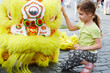 Photo: Girl sits near to yellow dragon Girl sits near to yellow dragon
