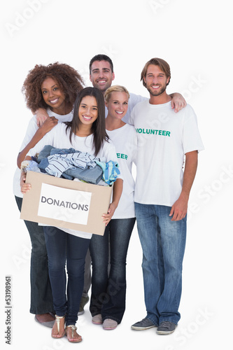 Photo: Happy group of volunteers holding donation box Happy group of volunteers holding donation box