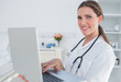 Photo: Woman doctor using laptop Woman doctor using laptop