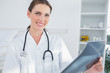 Photo: Smiling woman doctor holing a radiography Smiling woman doctor holing a radiography