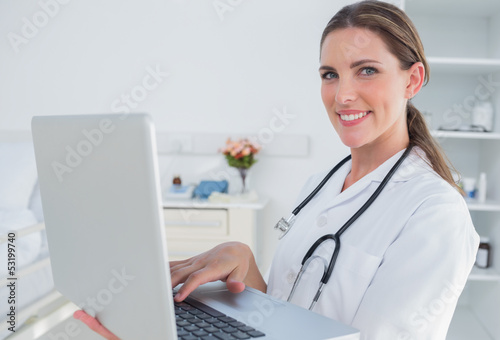 Photo: Woman doctor using laptop Woman doctor using laptop