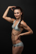 Photo: Young fitness woman in bikini flexing bicep Young fitness woman in bikini flexing bicep