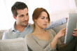 Photo: Couple reading news on both press and internet Couple reading news on both press and internet