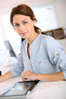 Girl in office working on digital tablet