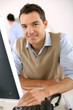 Man working in office in front of desktop computer