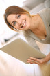 Photo: Smiling girl websurfing on internet with tablet Smiling girl websurfing on internet with tablet