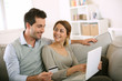 Couple using credit card to shop on internet