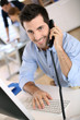 Smiling office worker talking on the phone