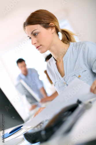 Photo: Young woman working on desktop computer Young woman working on desktop computer