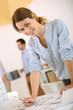 Young woman architect working in office