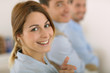 Photo: Cheerful girl in office showing thumbs up Cheerful girl in office showing thumbs up