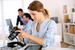 Young photo reporter working in office