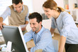 Workteam in office working on desktop computer