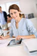 Foto: Girl in office working on digital tablet Girl in office working on digital tablet