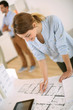 Young woman architect working in office