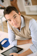 Handsome guy working with tablet in office