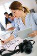 Girl in office working on digital tablet