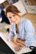 Photo: Portrait of cheerful girl in office Portrait of cheerful girl in office