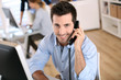 Smiling office worker talking on the phone