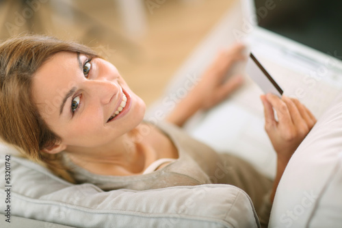 Photo: Upper view of woman in sofa shopping on internet Upper view of woman in sofa shopping on internet