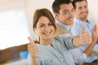 Photo: Cheerful girl in office showing thumbs up Cheerful girl in office showing thumbs up