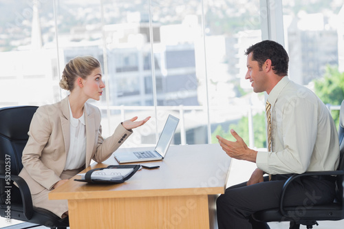 Photo: Businesswoman interviewing a smiling businessman Businesswoman interviewing a smiling businessman