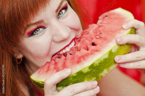 Photo: bright girl enjoying sweet watermelon bright girl enjoying sweet watermelon
