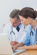 Two doctors working on a folded
