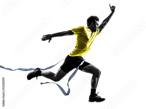 Photo: young man sprinter runner running winner finish line silhouette young man sprinter runner running winner finish line silhouette