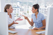 Businesswomen arguing at their desk