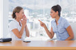Businesswoman pointing to a colleague
