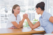 Businesswomen having an arm wrestle