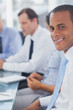 Photo: Happy businessman posing in the meeting room Happy businessman posing in the meeting room