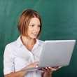 Foto: Woman working on a laptop in the school Woman working on a laptop in the school