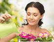housewife with flower in pot and watering can