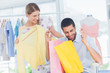 Photo: Man sitting in a boutique holding shopping bags Man sitting in a boutique holding shopping bags