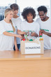 Volunteers putting food in donation box