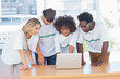 Photo: Volunteers working together on a laptop Volunteers working together on a laptop