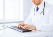 male doctor typing  on the keyboard