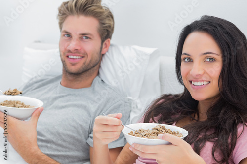 Photo: Couple eating cereal for breakfast Couple eating cereal for breakfast