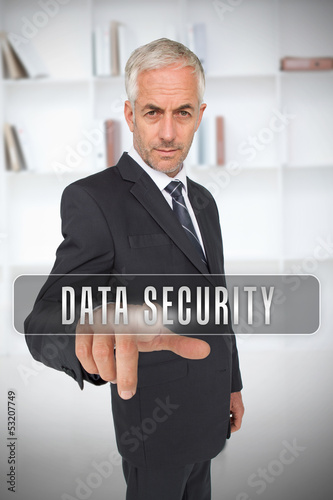Photo: Businessman selecting the term data security Businessman selecting the term data security