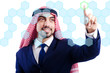 Arab man pressing virtual buttons