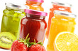 Foto: Composition with jars of fruity jams on white. Preserved fruits Composition with jars of fruity jams on white. Preserved fruits
